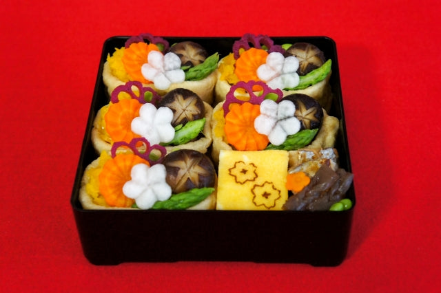 Bento box featuring decoratively cut  vegetables