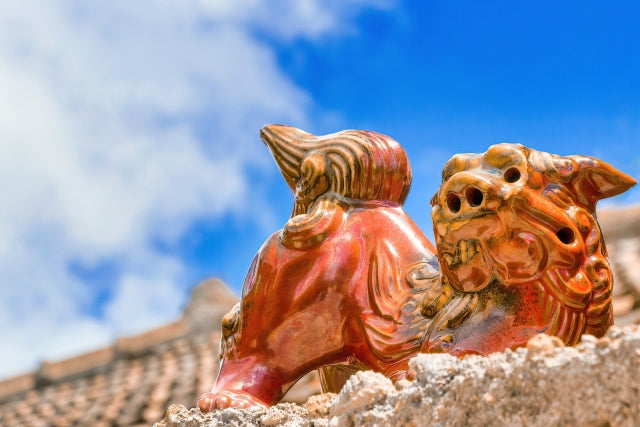 Okinawan shisa (guardian lion/ dog) on a rooftop with clear blue sky in the background